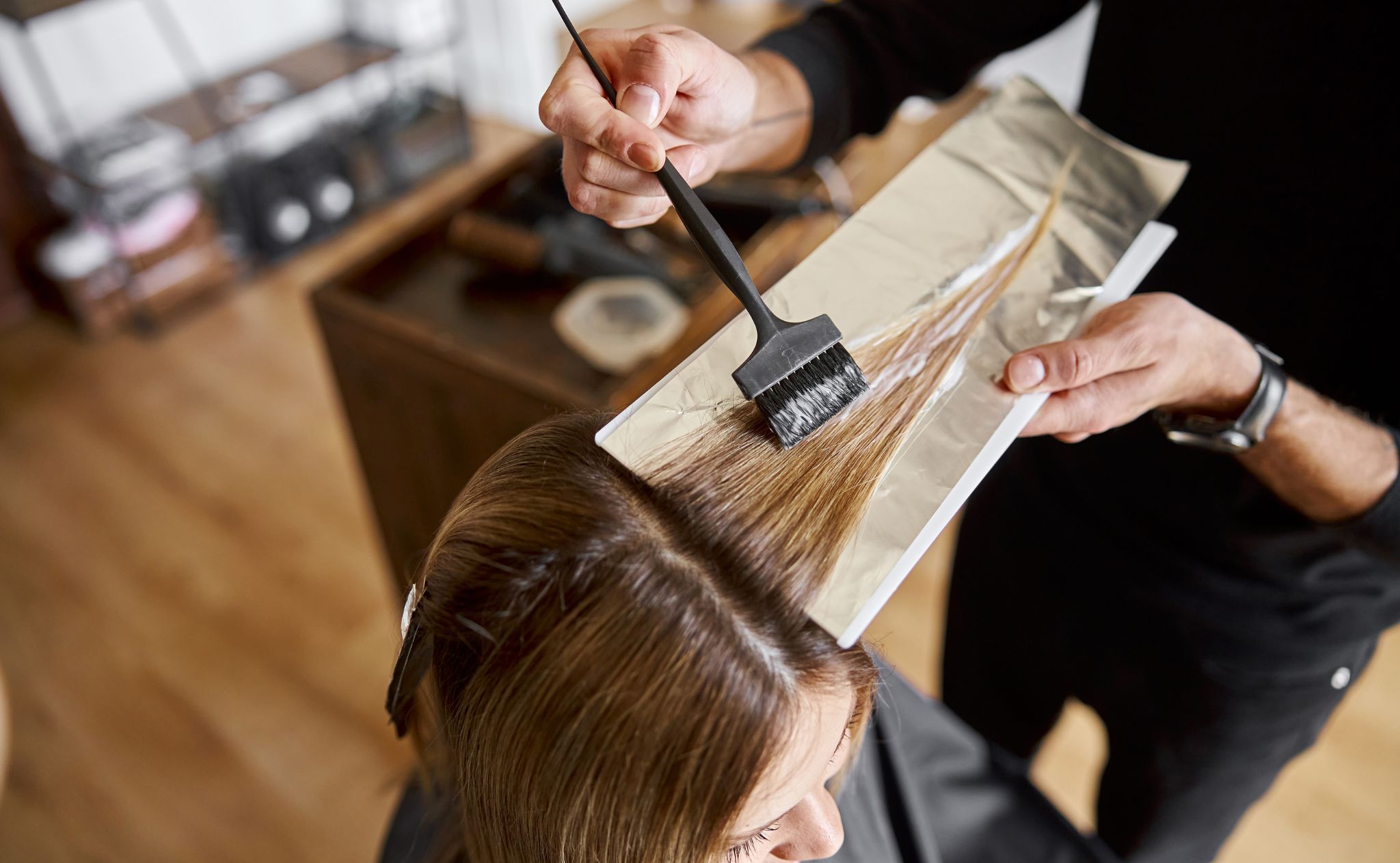 stylist highlighting hair